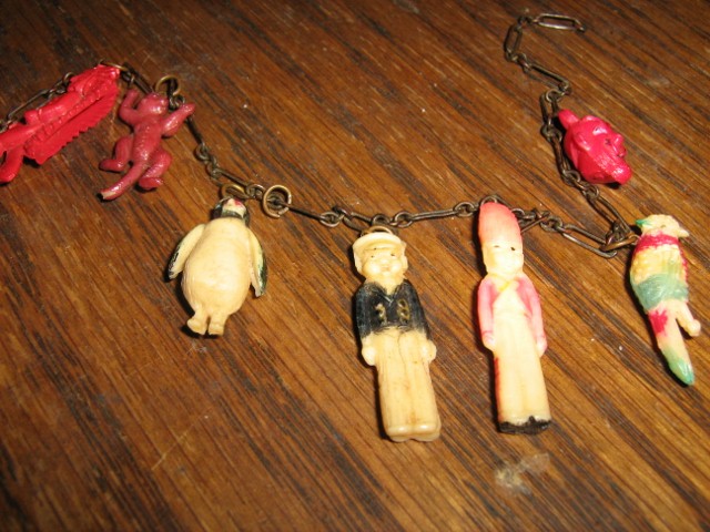 Photo of plastic charms with metal rings;all marked Japan except bird marked Hawaii